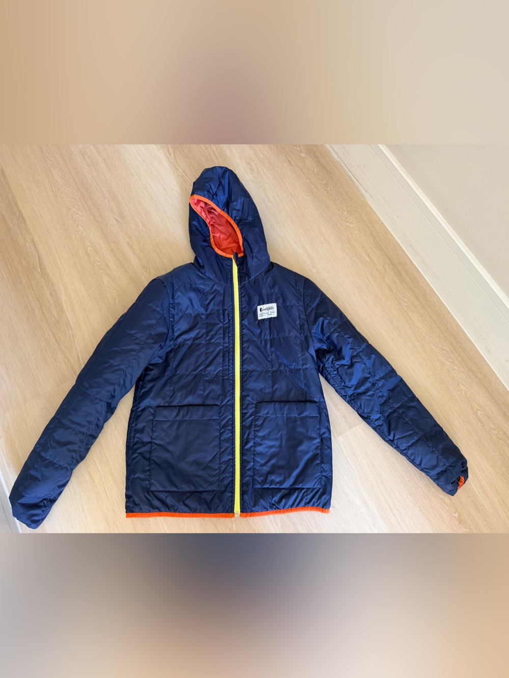 cotopaxi Navy Hooded Puffer Jacket with Orange Trim and Yellow Zipper